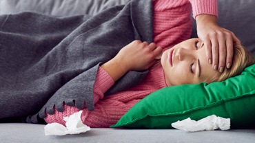 Sick woman holding her head Thumbnail